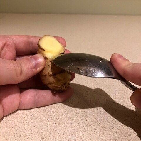 peeling ginger with a spoon